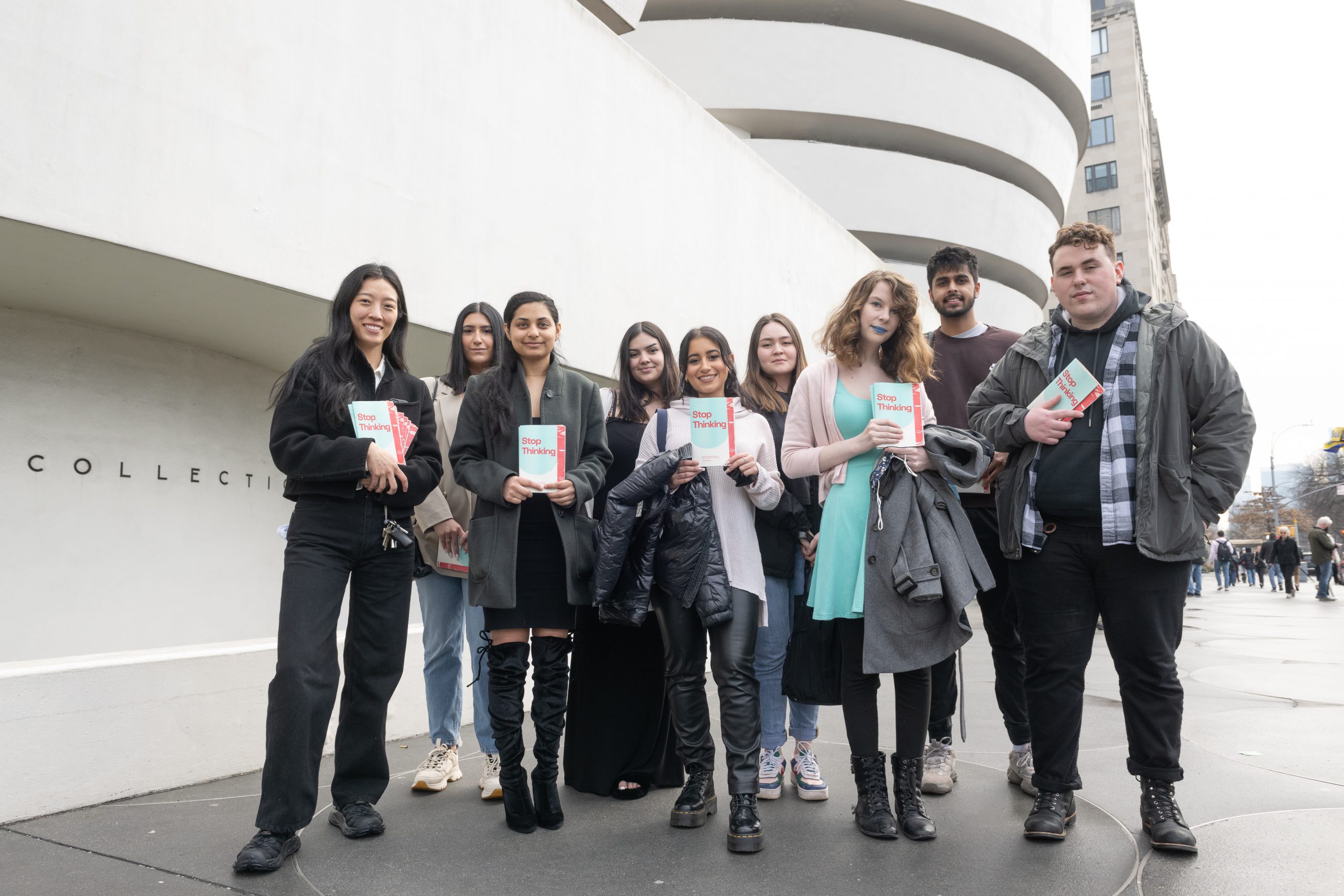 Design Practicum students and professor Mindy Seu stand in front of the Solomon R. Guggenheim Museum holding their designed activity booklets inspired by the artworks on view by Vasily Kandinsky and Jennie C. Jones for the Aye Simon Reading Room